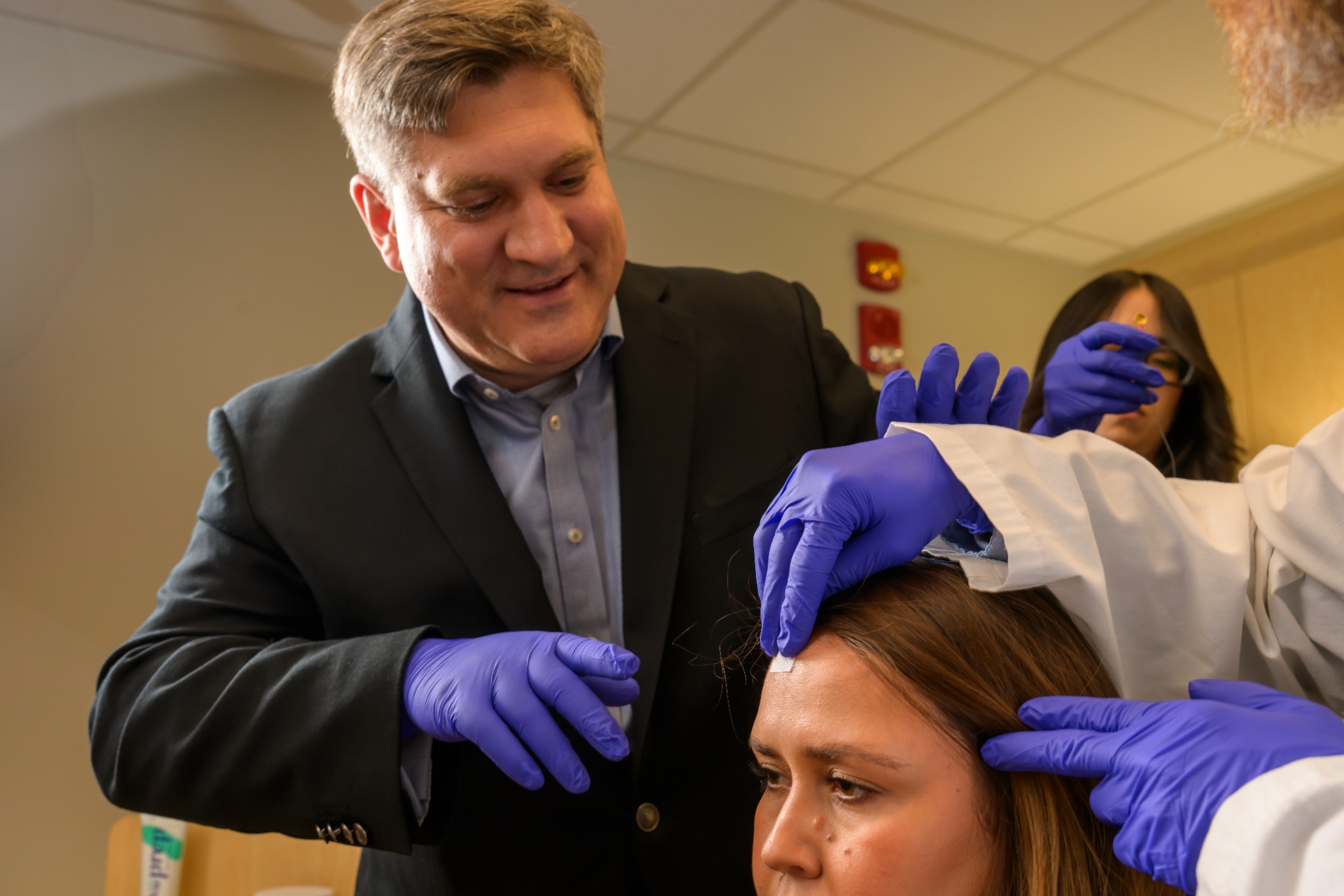 Michael Grandner participating in sleep research measurement setup